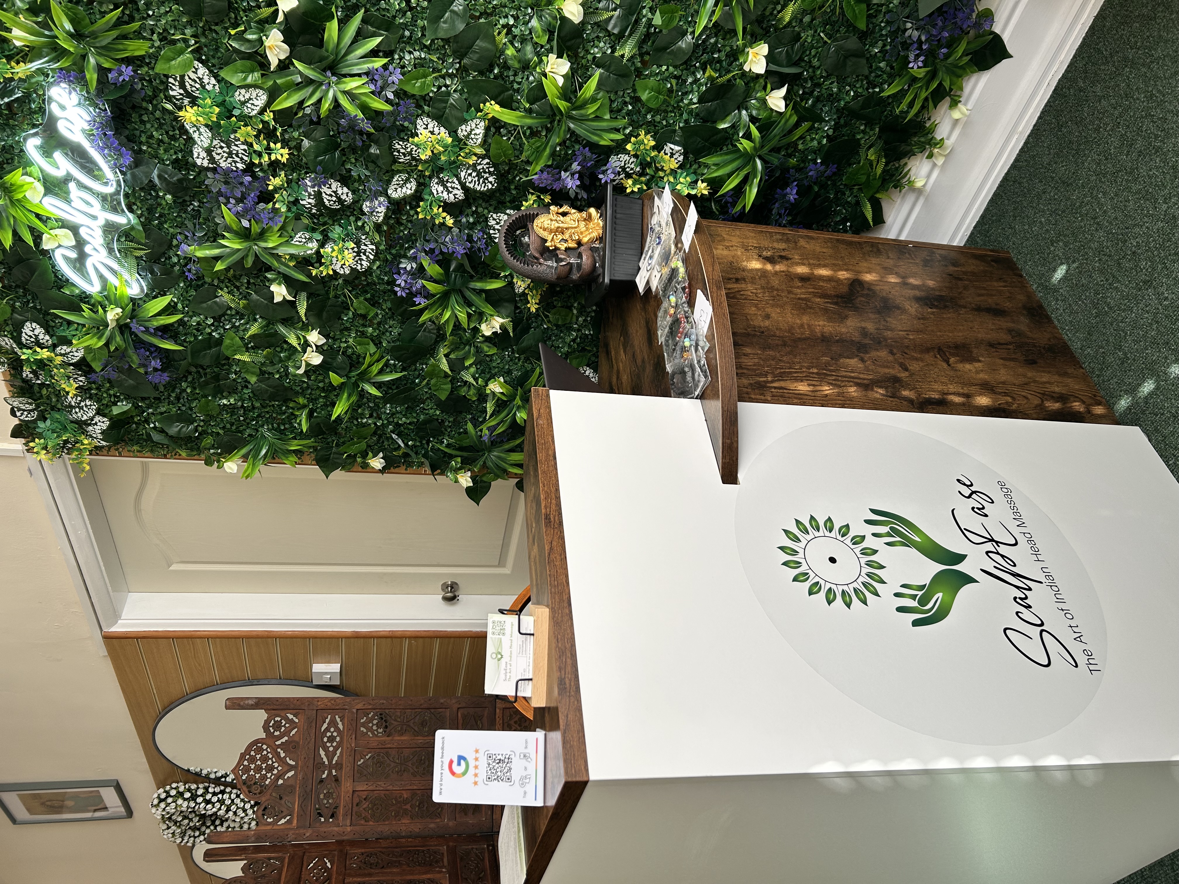 Front desk and greenery wall